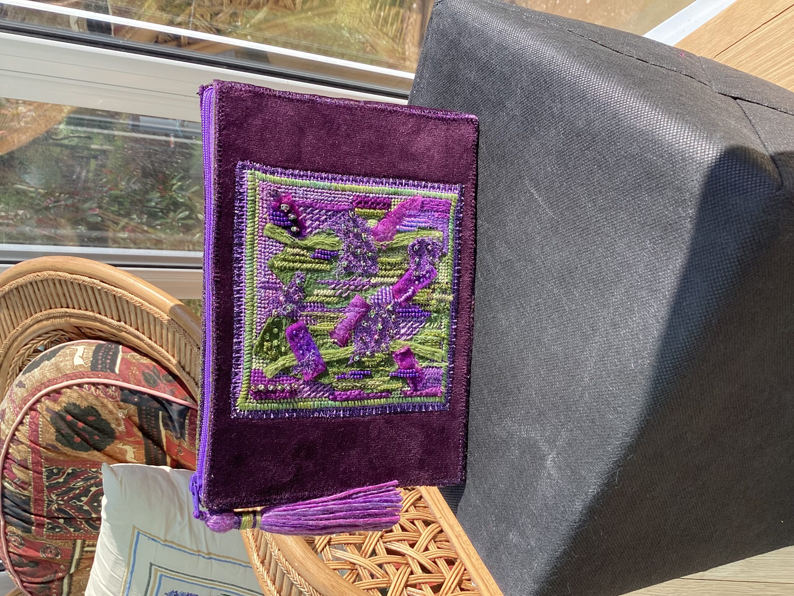 Purple velvet clutch bag, with embroidered panel.